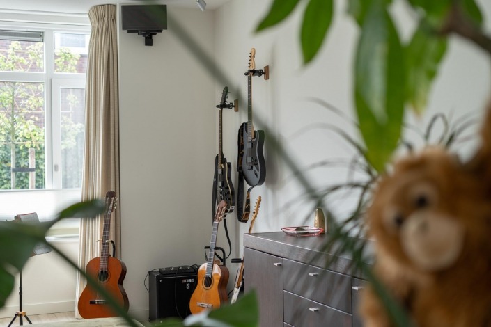 detailfoto gitaarcollectie in woonkamer